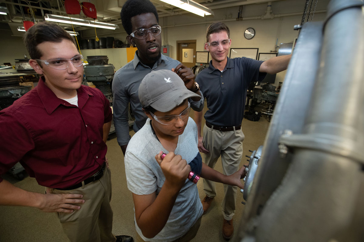 ERAU students working on a jet engine