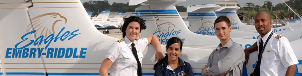 A group of pilots stand in front of the Embry-Riddle fleet.