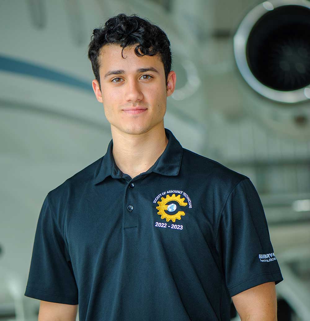 Javier Hernandez Rizo stands in front of plane engine