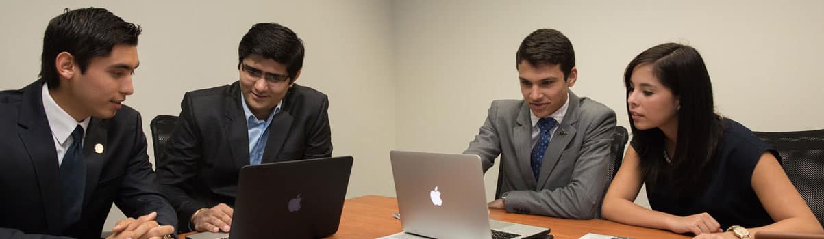 a group of students working on laptops