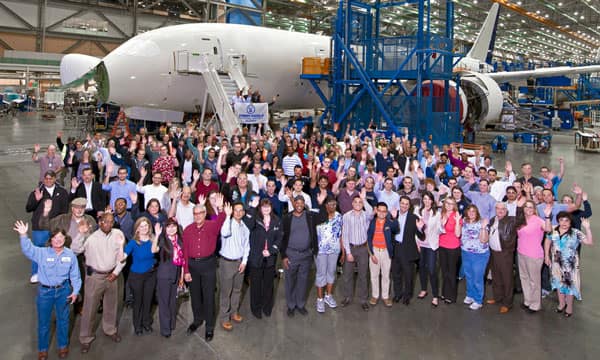 Group of ERAU alumni in a Boeing hangar with a large aircraft