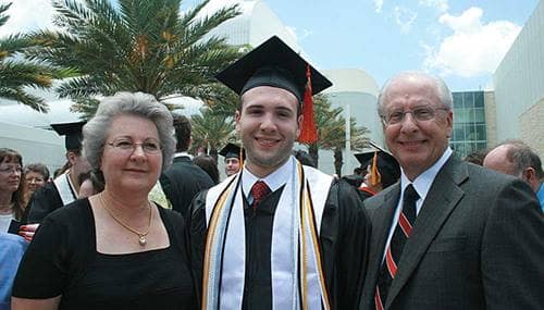 a student and his family at graduation