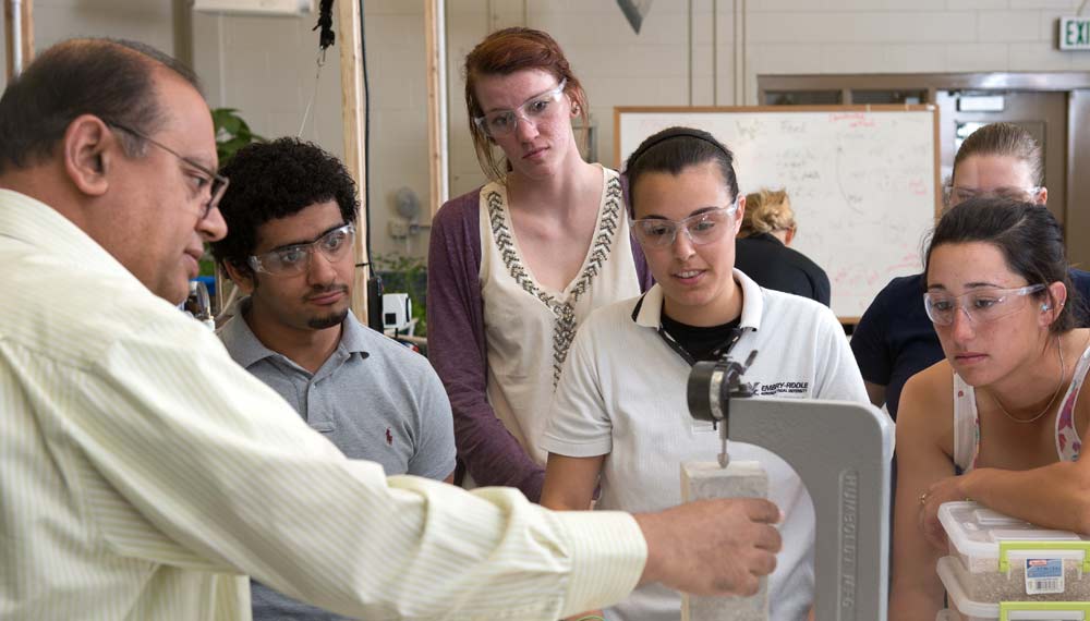 Embry-Riddle students work on an experiment in a lab.