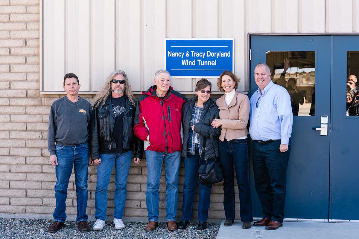 Todd Peterson, Todd Padget, Professor Tracy Doryland, Nancy Doryland, Peg Billson and Charles ‘Chuck’ Story stands in from of Doryland wind tunnel