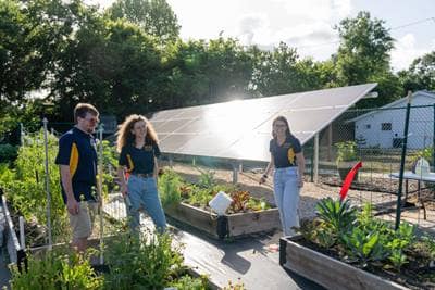 Students around solar panels