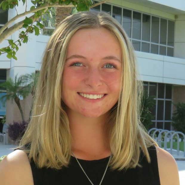 Stevie Albright stands in front of business building