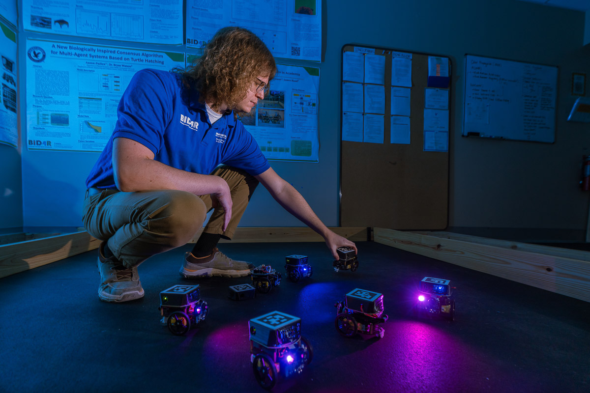 Embry-Riddle student James Hand handles small robots
