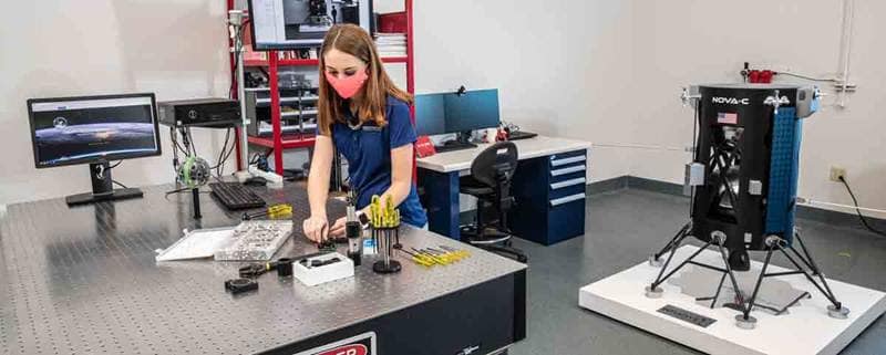 Taylor Yow, an Aerospace Engineering undergrad, examines a camera lens at the optical table in the Space Technologies Lab at Embry-Riddle Aeronautical University. The Niceville, Florida, resident works on EagleCam’s sensing team and oversees project management.